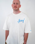 Man wearing Blue Jersey Love Tee in Natural by Wakefield District. Premium streetwear fit with blue graphic text.