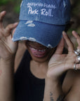 Model wearing the Denim Blue Signature Pork Roll Hat from the Contant Avenue collection by Wakefield District. Lifestyle portrait highlighting the white embroidered crossed-out Taylor Ham graphic.
