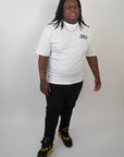 man in white contant avenue JRSY t-shirt