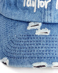 Close-up of distressed brim on blue denim Taylor Ham cap