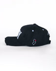 Side view of black baseball cap with embroidered NJ outline and heart detail