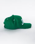 Angled side view of green baseball cap with distressed finish