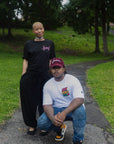 woman standing and man kneeling outdoors wearing eight seven six scribble t-shirt