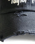 Contant Avenue black distressed baseball cap with white Taylor Ham Pork Roll embroidery design