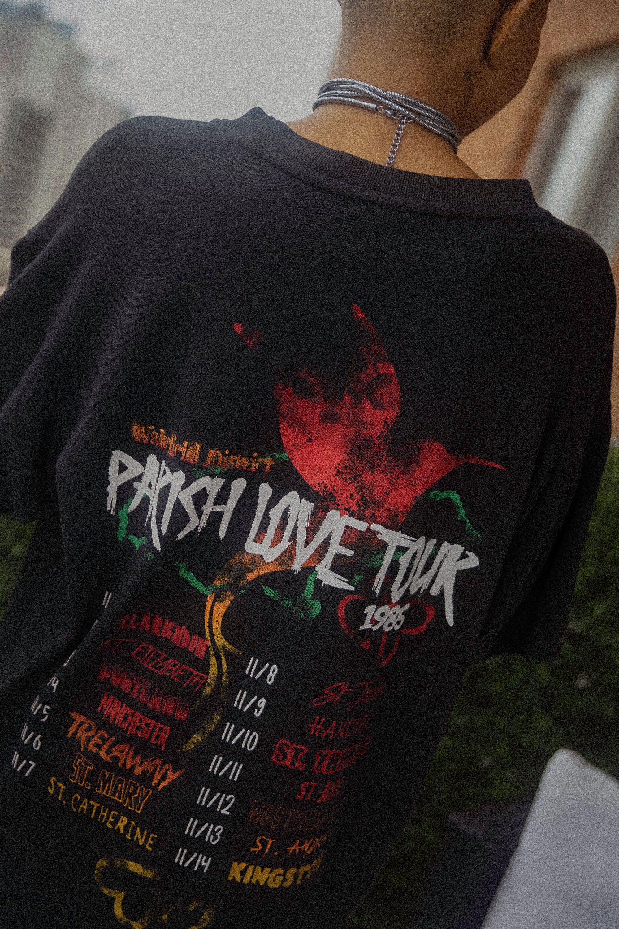 black parish love tour t-shirt back graphic with tour dates worn outdoors