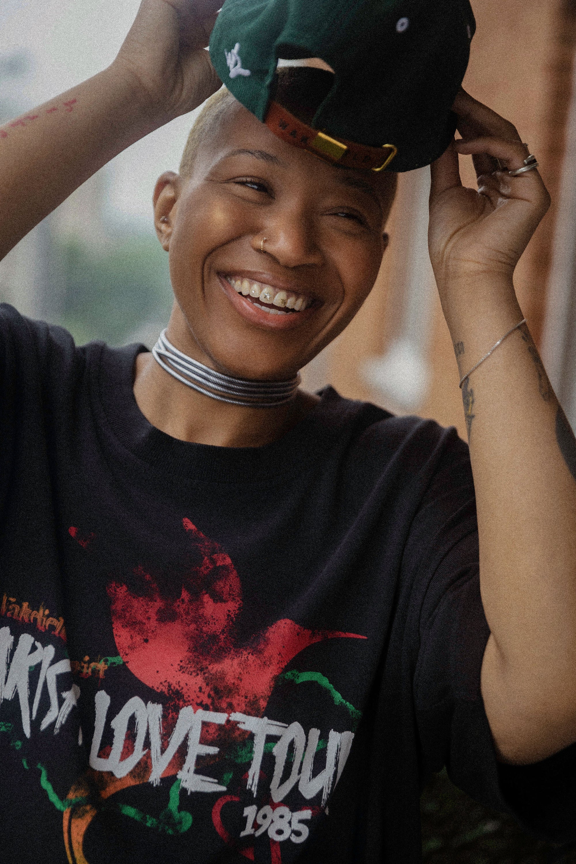 woman wearing black parish love tour t-shirt smiling outdoors casual streetwear