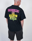 back view of man wearing contant avenue black and sunset jersey signature graphic t-shirt