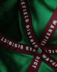 Vertical macro shot of the inside of the Jamaica Signature Cord Hat, showing the luxury emerald green satin lining and custom burgundy Wakefield District interior taping.