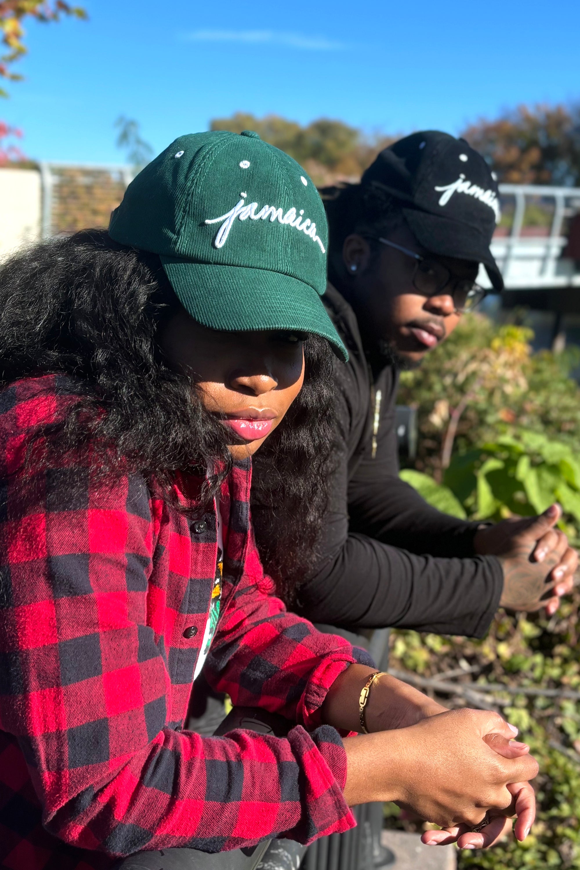 man and woman wearing Wakefield District Jamaica Signature Cord Hat in black and Jasper green