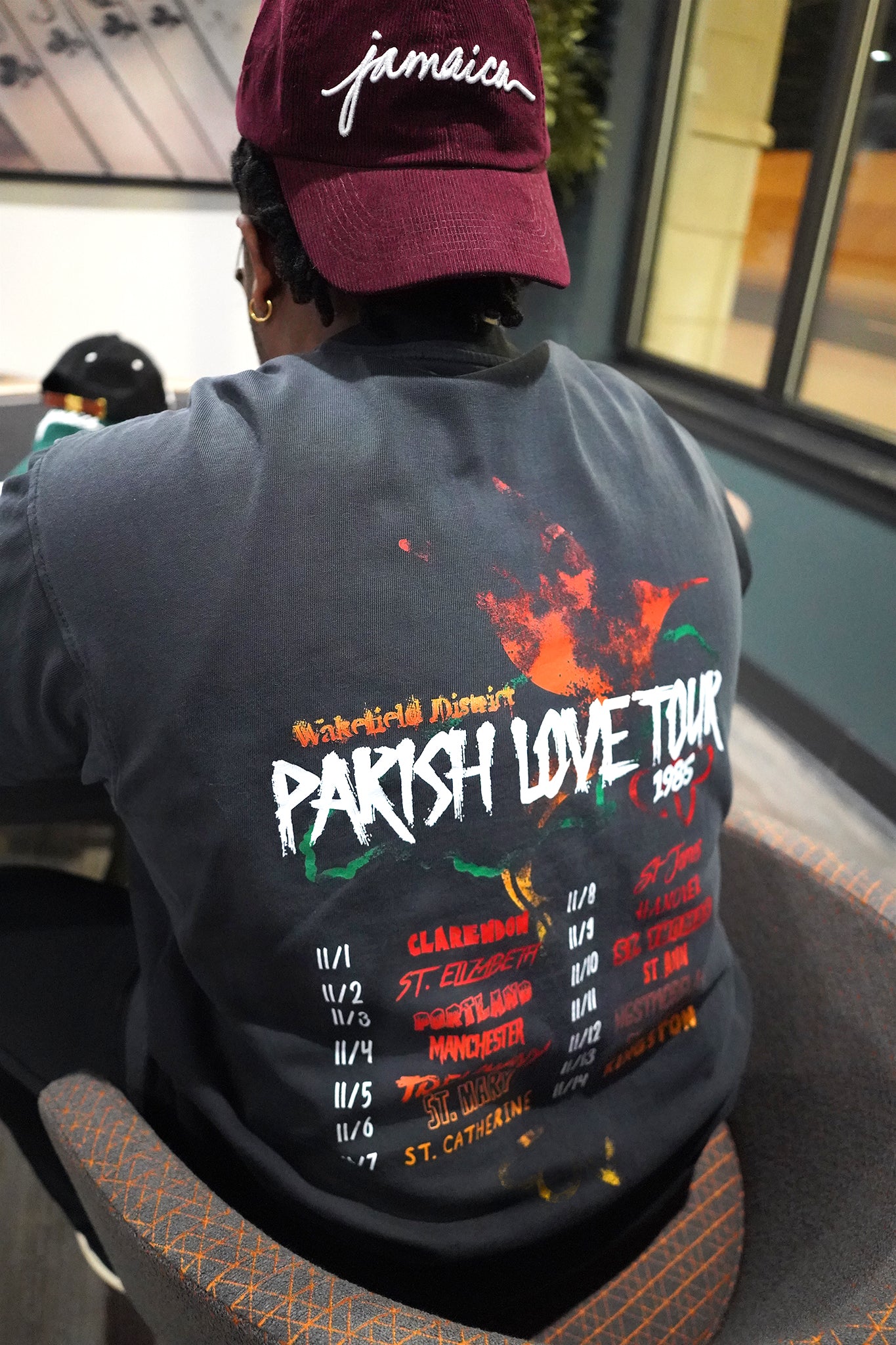 back view of man wearing black Wakefield District Jamaica parish t-shirt