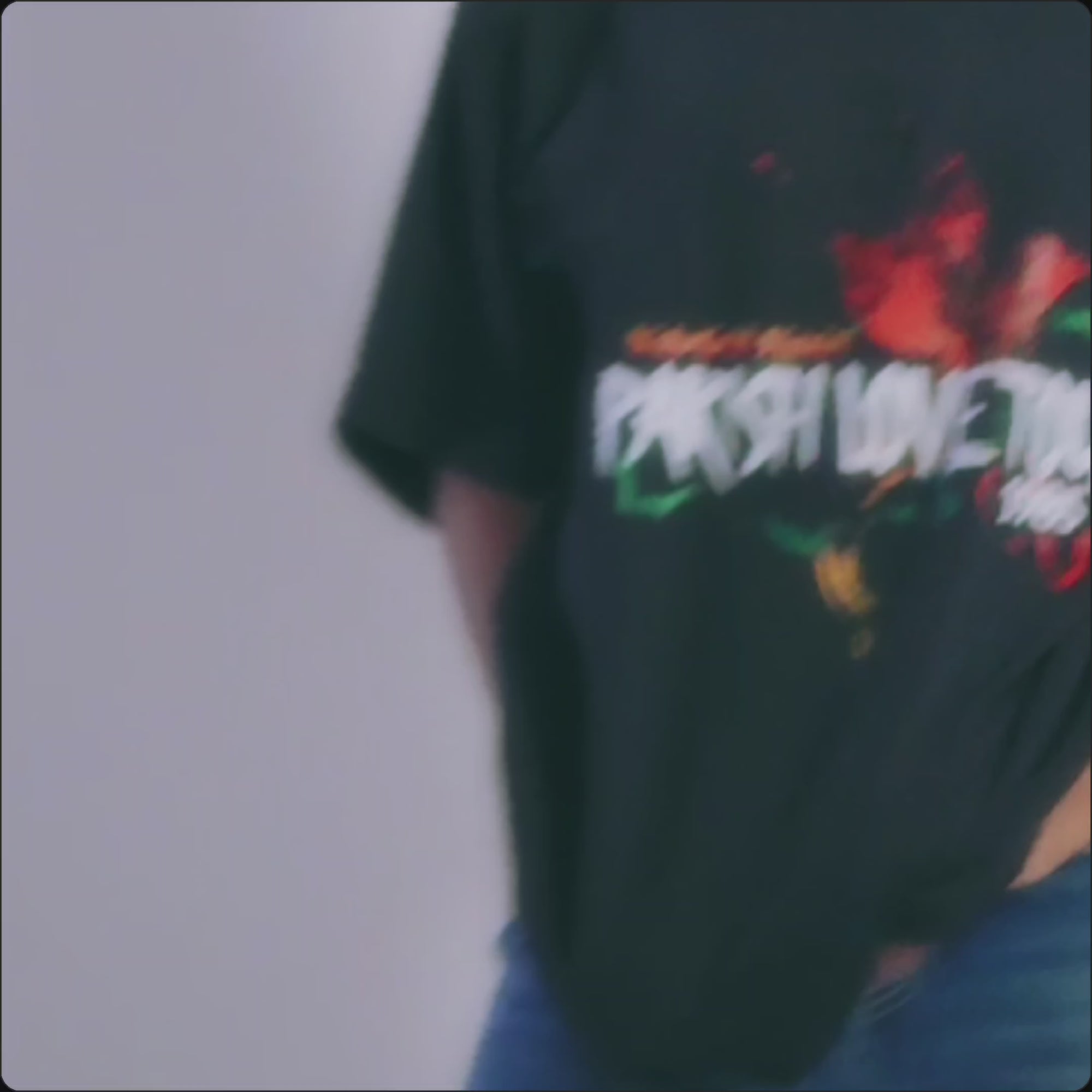 Video of woman wearing black Wakefield District Parish Love Tour Tee during photoshoot.