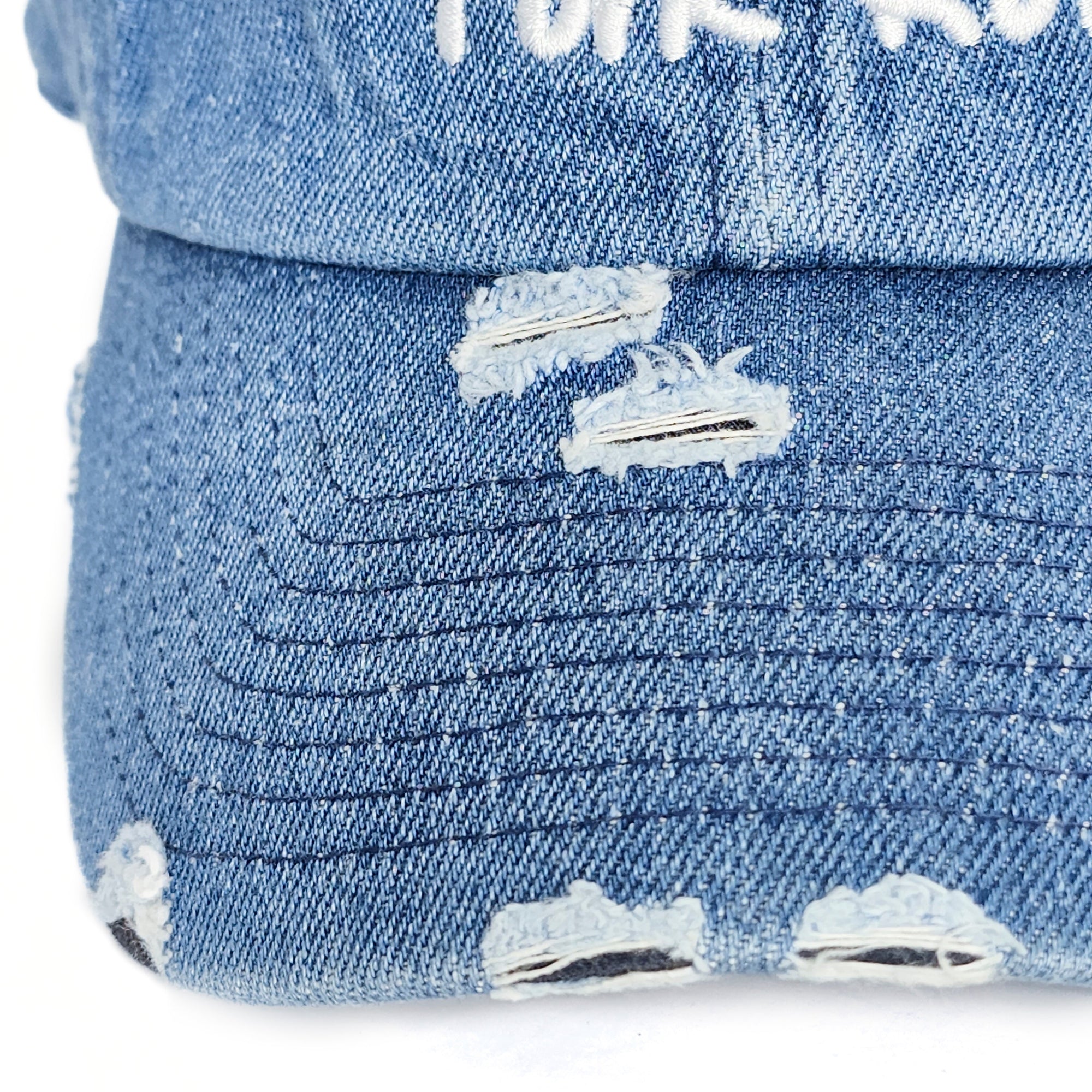 Close-up detail of the vintage distressed brim on the Denim Blue Signature Pork Roll Hat by Wakefield District, part of the Contant Avenue collection.