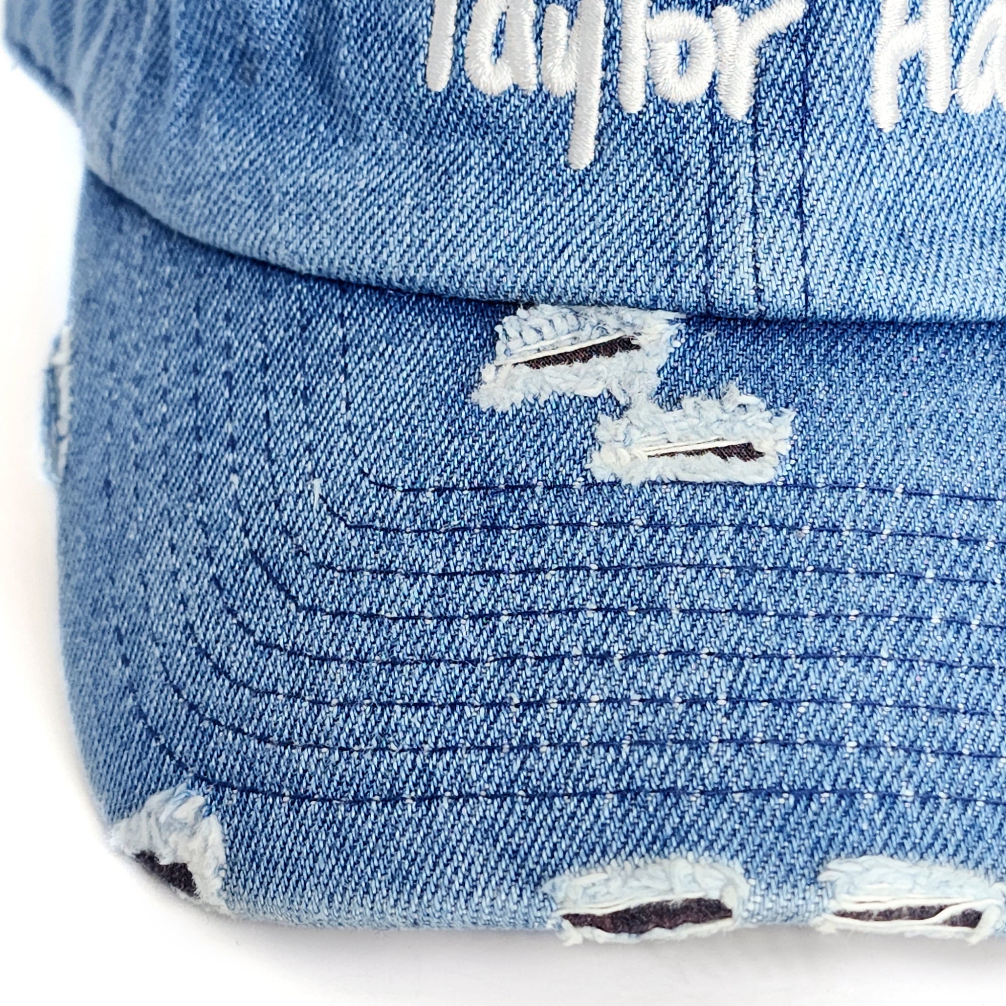 Close-up detail of the vintage distressing and heavy white embroidery on the Denim Blue Signature Taylor Ham Hat by Wakefield District, Contant Avenue collection.