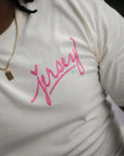 Close-up of pink Jersey script graphic on natural t-shirt