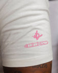 Sleeve detail of natural t-shirt with small pink logo print