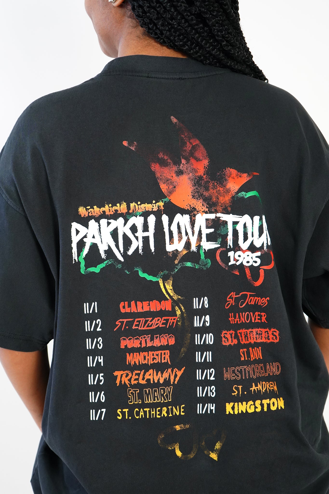 back view of woman wearing black Wakefield District Jamaica parish t-shirt